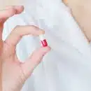 Crop nurse demonstrating small double colored pill
