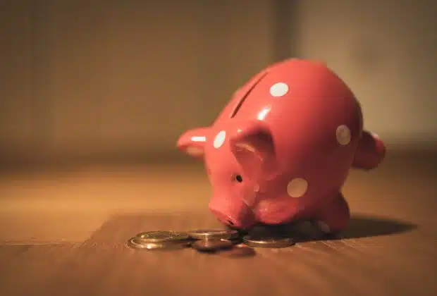 pink pig coin bank on brown wooden table